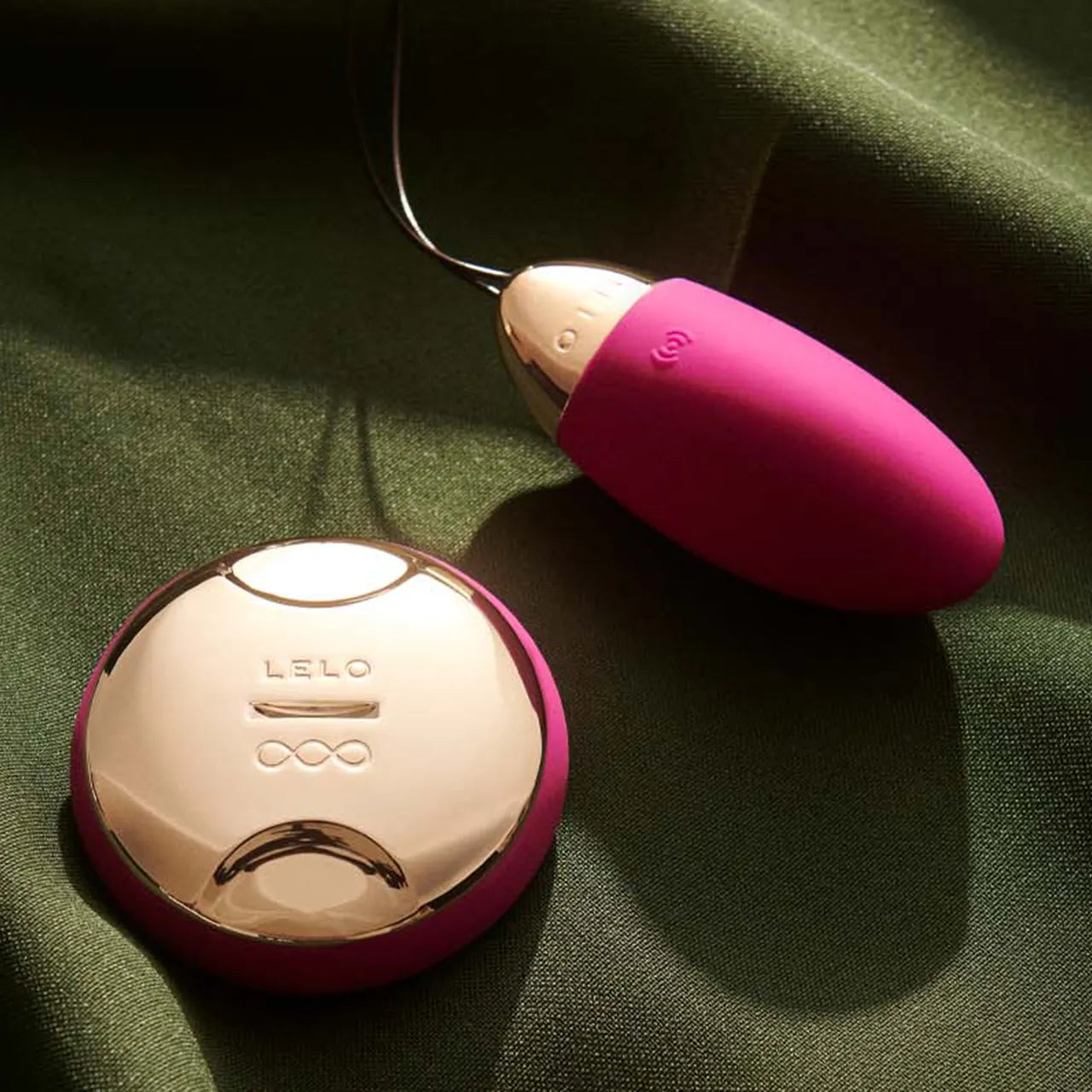 remote controlled vibrator lying on a dark silk sheet